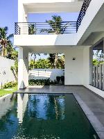 The swimming pool.

Straight ahead is the poolside deck above which is another partly covered deck to lounge in.